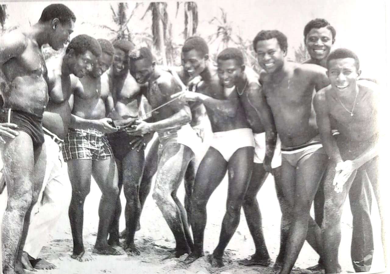From the Archives. Mr Kwamena Biney, chairman of Accra Great Olympics taking it easy at he Beach with his players in the late 60s.
